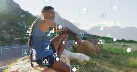 Image of eco icons over african american male hiker looking at landscape. Nature and econ awareness...