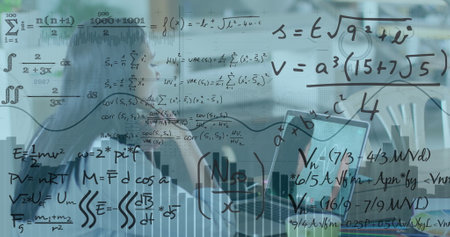 Image of mathematical equations over businesswoman using laptop. Global business, computing and digital interface concept digitally generated image.の写真素材