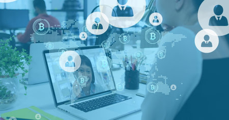 Image of bitcoins and user icons over caucasian woman having image call on laptop. Social media, communication, business and technology concept digitally generated image.の写真素材