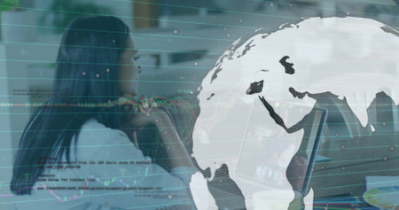 Image of graphs, globe and data over woman having image call on laptop. Business, finance, economy and technology concept digitally generated image.の写真素材