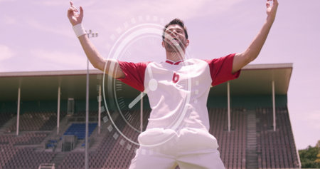 Image of clock over successful and happy caucasian male soccer player. Sport, training, math and time concept digitally generated image.の写真素材