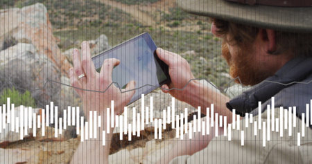 Image of data processing over caucasian male hiker with tablet in mountains. International mountain...