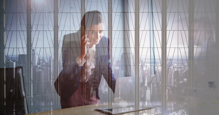 Image of caucasian businesswoman talking on cellphone over cityscape. digital composite, multiple exposure, entrepreneur, skyscrapers and technology concept.の写真素材