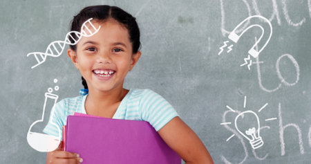 Image of school drawings over happy girl. School, education and learning concept digitally generated image.の写真素材