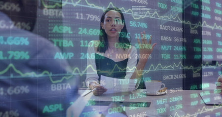 Image of financial data and graphs over woman in office. Business, finance, economy, cooperation and communication concept digitally generated image.の写真素材