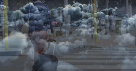 Image of clouds over african american businesswoman walking. Global business and digital interface concept digitally generated image.の写真素材