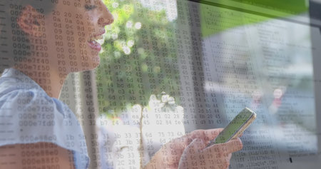 Image of lines and data processing over caucasian woman using smartphone. Data processing, communication and technology devices concept digitally generated image.の写真素材