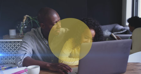 Image of yellow circles over african american man and his daughter using laptop together. Family,...