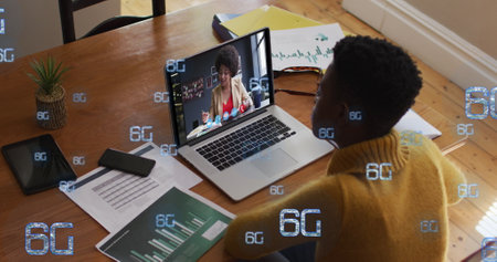 Image of 6g over african american woman having image call on laptop. Business, online working, communication and technology concept digitally generated image.の写真素材
