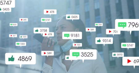 Image of social media icons with growing numbers over african american woman using smartphone. Global social media, technology and digital interface concept digitally generated image.の写真素材