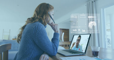Image of data processing over caucasian woman having a imagecall on laptop at home. Computer...
