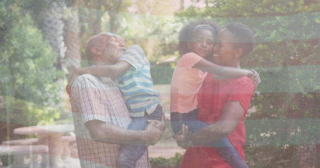 Image of flag of usa over african american family embracing. Patriotism, family and digital interface concept digitally generated image.の写真素材