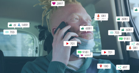 Image of social media icons with growing numbers over albino african american man. Global social media, technology and digital interface concept digitally generated image.の写真素材