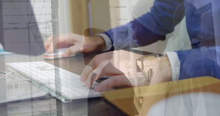 Image of hands using computer over diverse business people in office. Global business and digital...