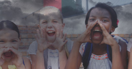 Image of sky with clouds over diverse schoolchildren screaming. Global education and digital interface concept digitally generated image.の写真素材