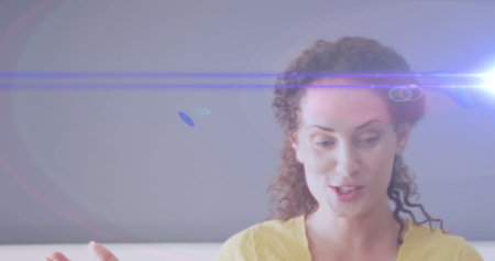 Image of light trails over caucasian female teacher holding. Global education and learning concept...