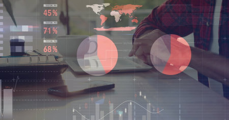 Image of financial data and graphs over hands of caucasian man using laptop. Finance, economy,...