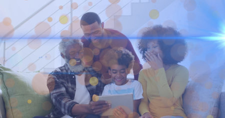 Image of dots moving over happy african american multi generation family using tablet. Family, spending quality time together concept digitally generated image.の写真素材