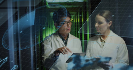 Image of data processing over diverse workers in server room. Global business and digital interface concept digitally generated image.の写真素材