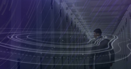 Image of topography and light trails falling over male engineer walking in server room. Global...