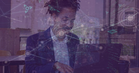 Image of network of connections over caucasian businessman using laptop at a cafe. Global networking...