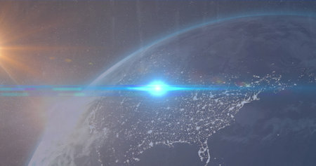 Image of blue light spot over globe against blue background. Global networking and business...