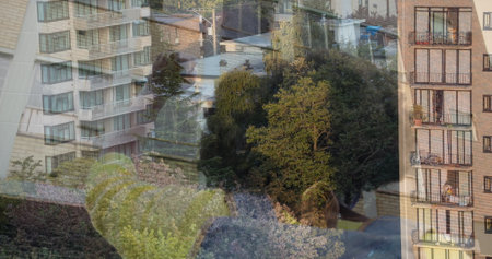 Woman in sweater pressing face against apartment window glass viewing stucco brick balconies, trees....
