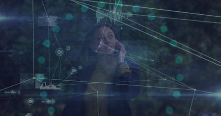 Image of network of connections over african american businesswoman talking on smartphone. Global...