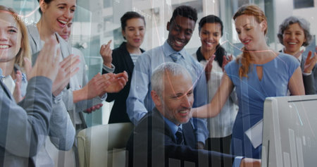 Image of graphs over diverse businesspeople working in office. Business, finance and economy concept digitally generated image.の写真素材