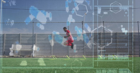 Image of interface with medical structures over male player jumping on playground. Digital composite, multiple exposure, medical, molecule, exercising, soccer, competition and sport concept.の写真素材