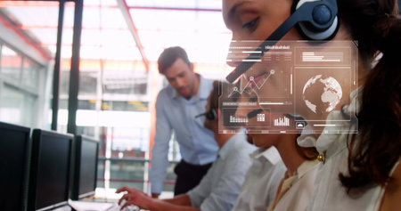 Listening agent wearing headset handling call at call center, with digital overlay, copy space. Business, communication, technology, collaboration, modern, data, enterpriseの写真素材