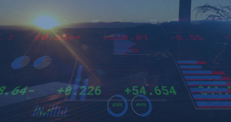 Displaying holographic overlay on balcony overlooking valley at sunset with dials and bar graphs. Futuristic, technology, financial, analytics, data visualization, modern, scenicの写真素材