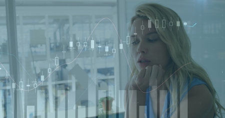 Woman analyst wearing sleeveless blouse studying digital charts at office desk, copy space....