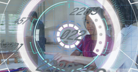 Pointing girl in red top interacting with holographic interface in home kitchen, with laptop....