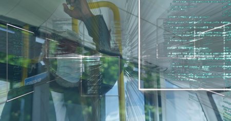 Standing male commuter gripping yellow handrail in bus, with Covid-19 poster and code panels. Urban, professional, modern, corporate, safety, digital, technologyの写真素材