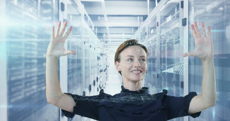 Engineer in ruffled top using holographic display in data center aisle, with server racks....