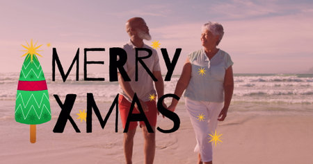 Mature couple walking hand in hand on sandy shoreline at sunset, with MERRY XMAS graphic overlay. Romance, leisure, serenity, celebration, harmony, tranquility, seasonalの写真素材