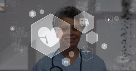Displaying woman in light blue scrubs with stethoscope and showing health icons in clinic corridor. Medical, clinical, healthcare, professionalism, technology, diagnostics, wellnessの写真素材