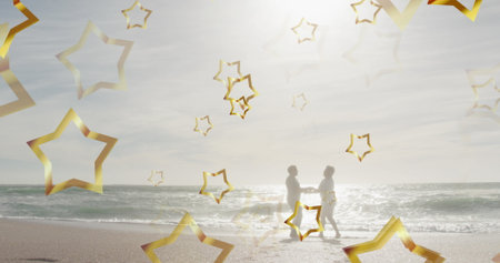 Dancing senior couple holding hands on sandy shoreline at ocean edge, with golden star outlines. Romance, serenity, leisure, reflection, nostalgia, tranquility, lifestyleの写真素材