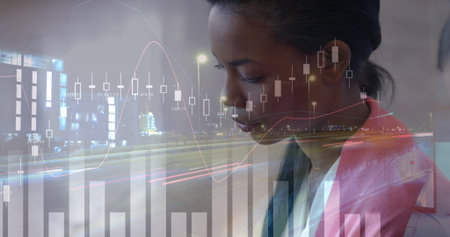 Woman in pink blazer and blouse tracking financial chart overlays on night city roadway, copy space....