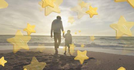 Walking father and son holding hands along seaside beach at sunset, with yellow star overlays....