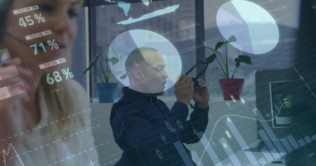 Observing mid adult man tapping smartphone at office with potted plants, digital testing charts. Technology, collaboration, innovation, modern, analytics, professional, workspaceの写真素材