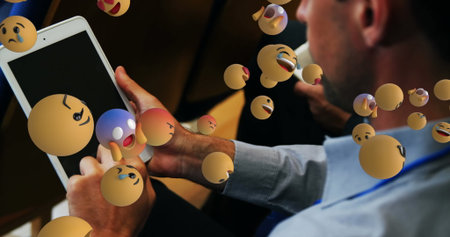 Blue shirt attendee interacting with tablet at seminar room, with floating 3D emoji, copy space. Technology, expression, communication, innovation, corporate, modern, engagementの写真素材