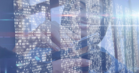 Interacting man wearing eyeglasses tapping smartphone screen near window, with binary code overlay. Technology, innovation, cybersecurity, data, digital, modern, professionalの写真素材