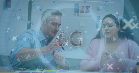 Colleagues gesturing toward charts and checking smartphone in office meeting room, with 6G overlay....