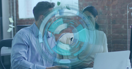 Collaborating coworkers viewing holographic interface at office desk, with laptop whiteboard sketch. Technology, teamwork, innovation, modernity, productivity, workspace, digitalの写真素材