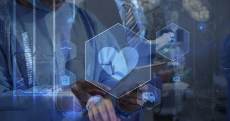 Collaborating clinical team in scrubs examining holographic icons on tablet, with stylus in lab. Medical, collaboration, technology, innovation, healthcare, digital, researchの写真素材