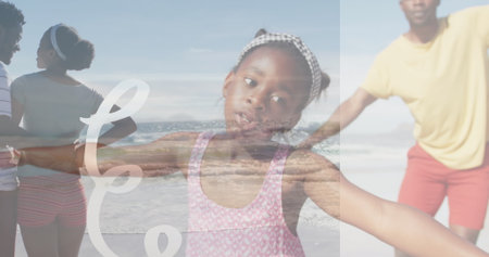 Spreading arms girl wearing pink swimsuit and gingham headband on sandy beach, family scene. Carefree, joy, leisure, outdoors, harmony, playfulness, togethernessの写真素材