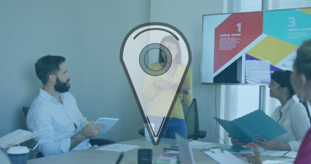 Presenter in yellow top explaining slide on display in boardroom with devices, paperwork....