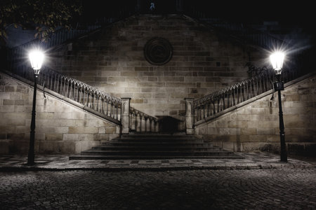 Stone staircase is splitting under glowing vintage lamps in flat design illustration, copy space. Urban, architecture, vintage, moody, historic, atmospheric, nocturnalの写真素材